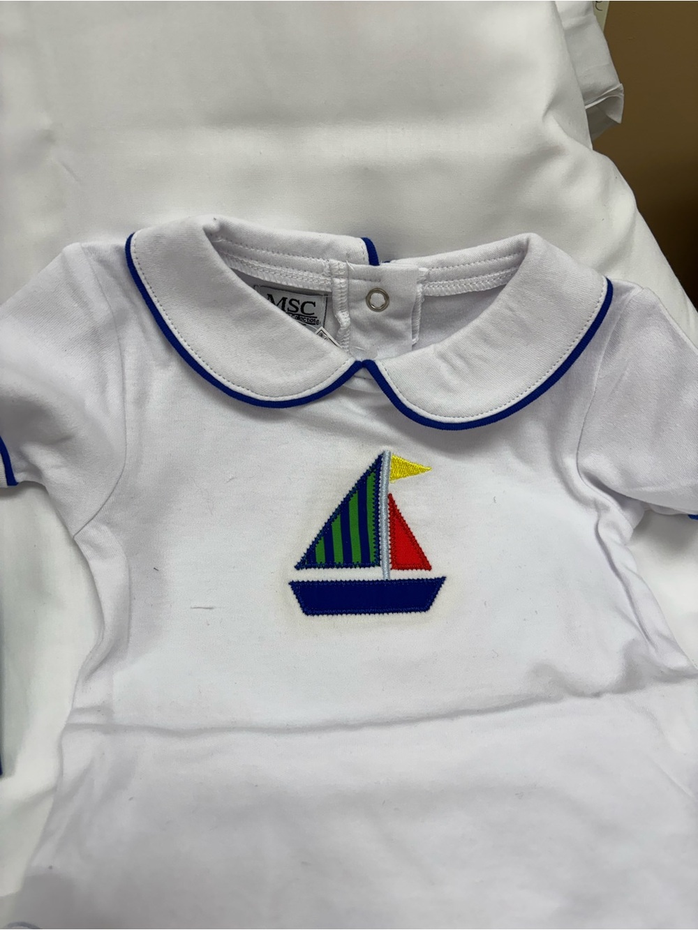 New White Baby Polo onsie set with Sailboat Applique.